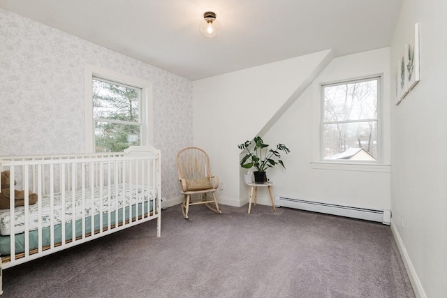 unfurnished bedroom featuring a nursery area, baseboard heating, and dark carpet