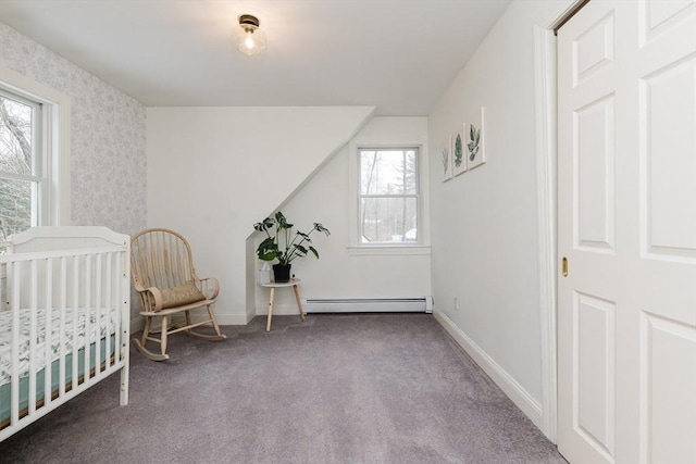 carpeted bedroom featuring a baseboard radiator and a crib