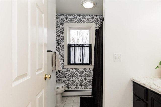 bathroom featuring vanity, toilet, a baseboard radiator, and tile patterned floors