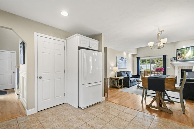 7 Myra Ln Unit 11, Worcester, MA 01606 - kitchen with freestanding refrigerator, open floor plan, light tile patterned floors, a chandelier, and recessed lighting