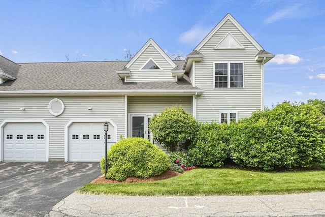 7 Myra Ln Unit 11, Worcester, MA 01606 - view of front of house featuring a garage, asphalt driveway, and roof with shingles