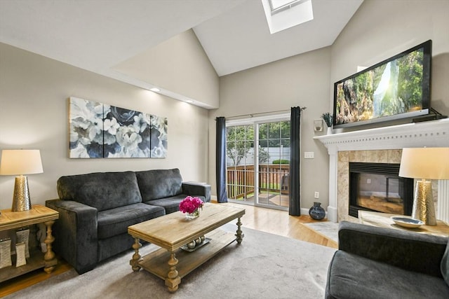 7 Myra Ln Unit 11, Worcester, MA 01606 - living room featuring wood finished floors, high vaulted ceiling, a skylight, baseboards, and a tile fireplace