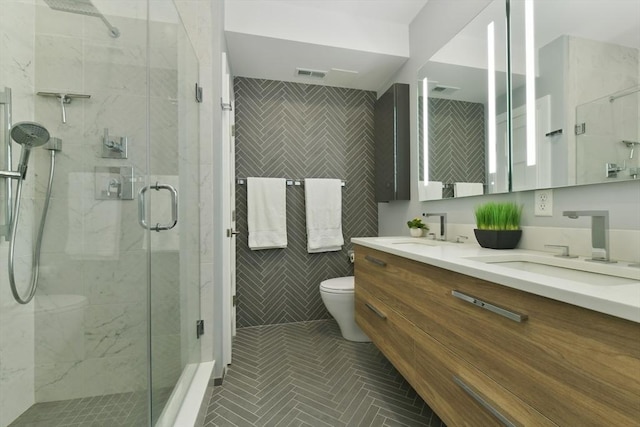 full bathroom with visible vents, a sink, tile walls, and toilet