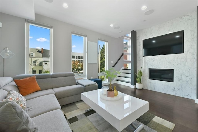 living room featuring a wealth of natural light, a fireplace, recessed lighting, and wood finished floors