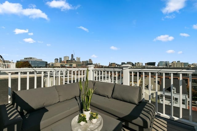 balcony featuring an outdoor living space and a city view