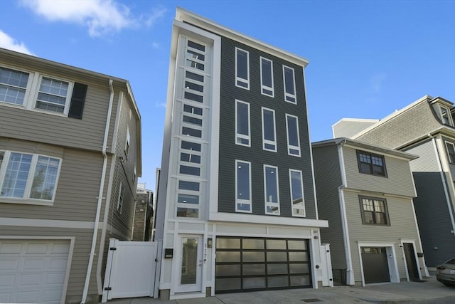 view of front facade featuring a garage and a gate