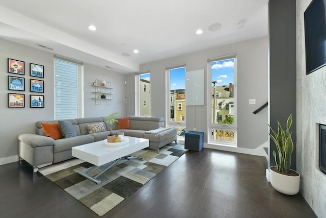 living area with a high end fireplace, recessed lighting, visible vents, and baseboards