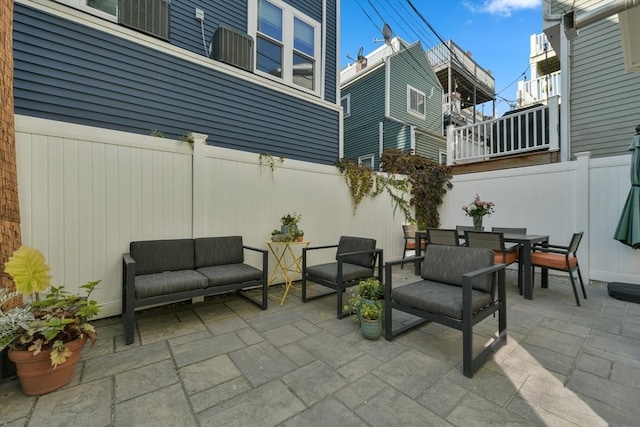 view of patio / terrace featuring fence, outdoor dining area, and an outdoor living space