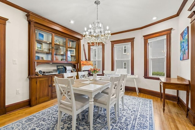 dining space with a chandelier, baseboards, light wood-type flooring, crown molding, and recessed lighting
