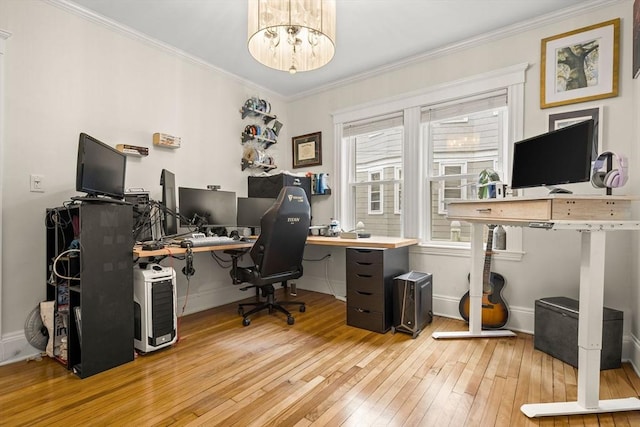 home office with hardwood / wood-style flooring, ornamental molding, baseboards, and a chandelier