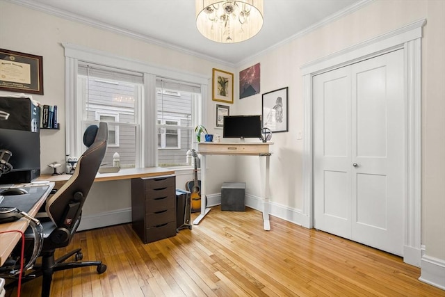 office area featuring light wood finished floors, crown molding, baseboards, and a chandelier