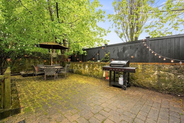 view of patio with a grill and a fenced backyard