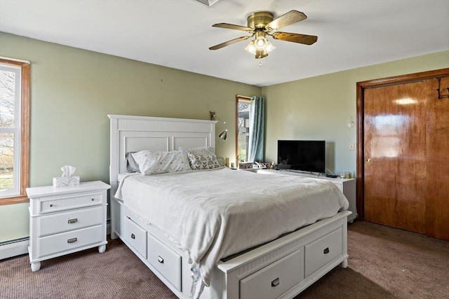 bedroom featuring multiple windows, ceiling fan, and dark colored carpet