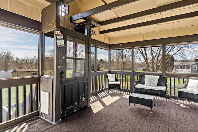 sunroom featuring beamed ceiling