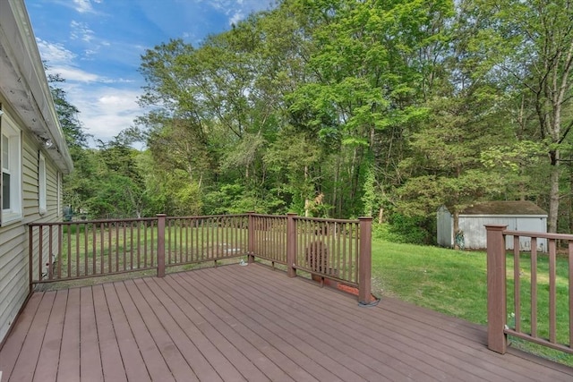 wooden terrace with a lawn, a storage unit, and an outdoor structure