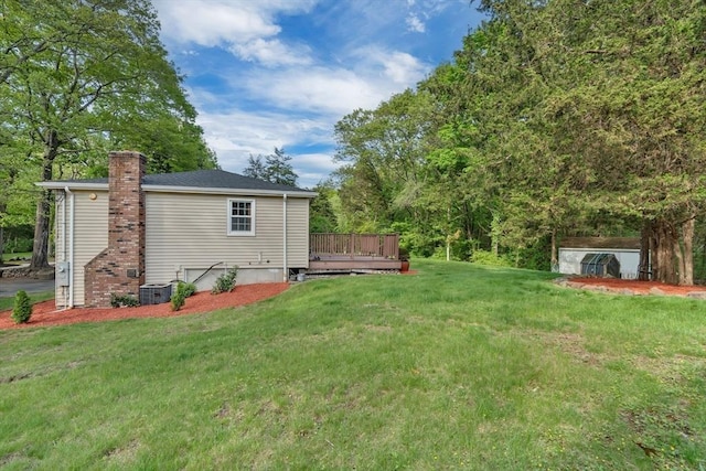 view of grassy yard featuring a deck and cooling unit