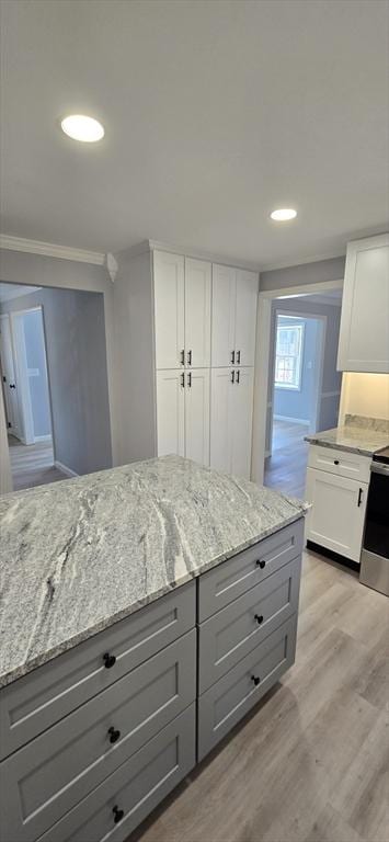 kitchen featuring gray cabinets, light wood-style flooring, white cabinetry, light stone countertops, and stainless steel electric range