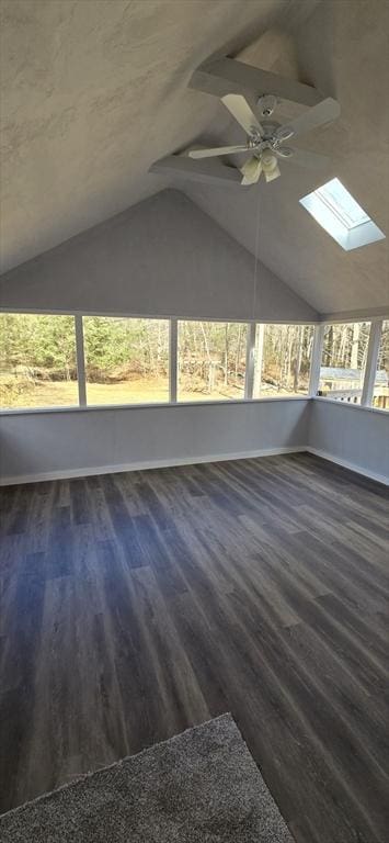 unfurnished sunroom with vaulted ceiling with skylight and ceiling fan