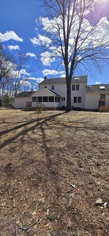 back of property with a sunroom