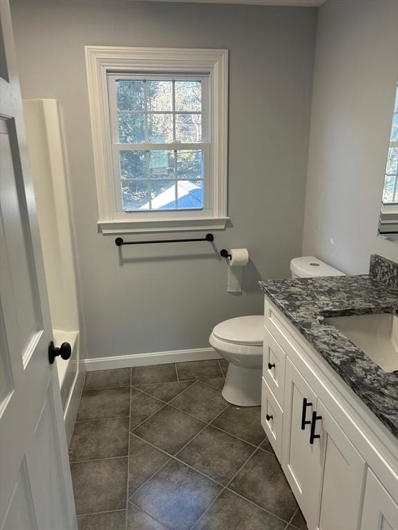 full bathroom with toilet, tile patterned floors, baseboards, and vanity