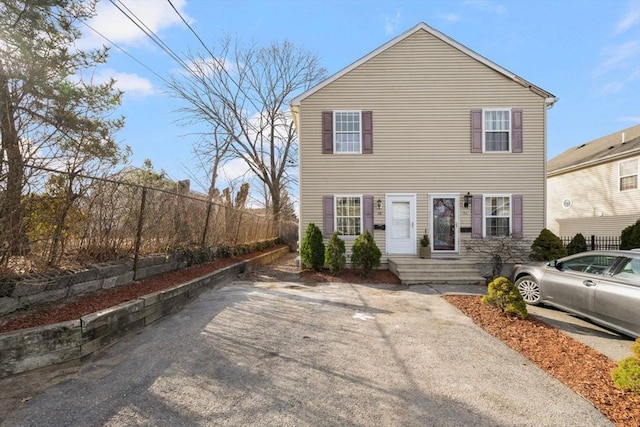 view of front of home featuring fence