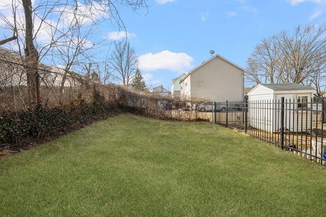 view of yard with an outbuilding and fence