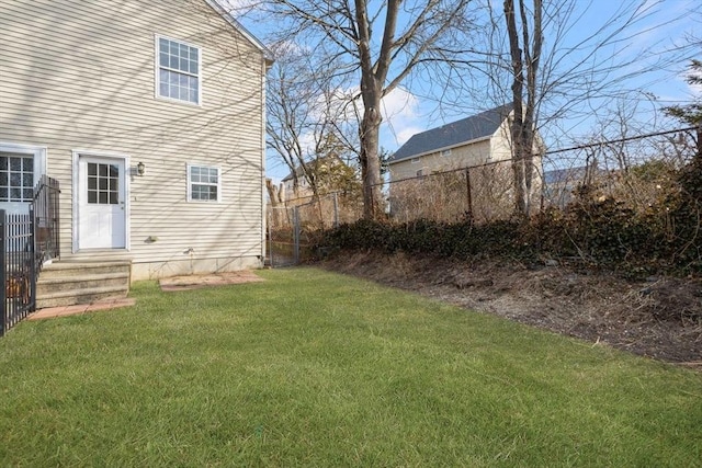 view of yard with entry steps and fence