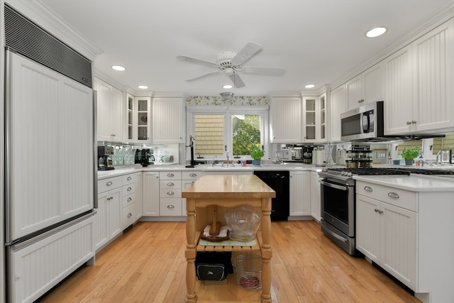 kitchen featuring white cabinets, light hardwood / wood-style flooring, and stainless steel appliances