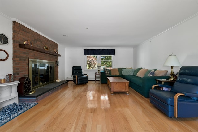 living room featuring a brick fireplace, light hardwood / wood-style flooring, a baseboard heating unit, crown molding, and brick wall