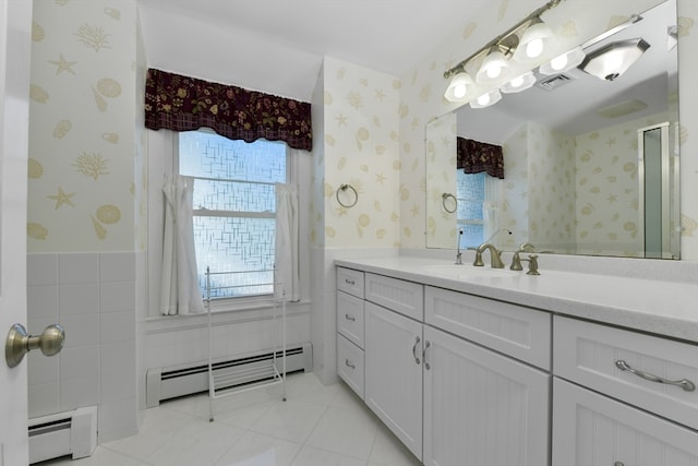 bathroom with tile patterned flooring, tile walls, a baseboard heating unit, and vanity