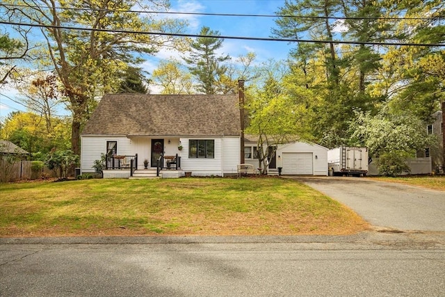 cape cod house with aphalt driveway, an outdoor structure, a garage, and a front yard