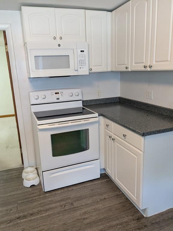 9 New Boston Rd, Dudley, MA 01571 - kitchen featuring white appliances, dark countertops, white cabinets, and dark wood-type flooring
