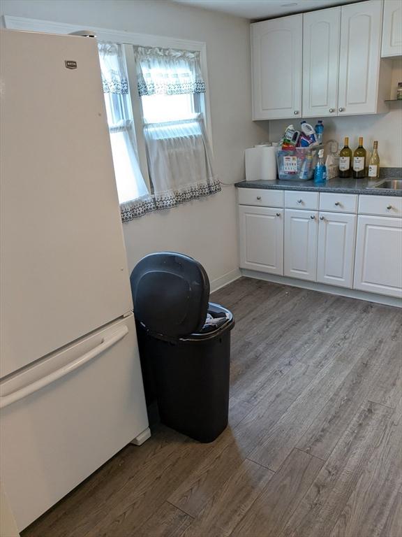 9 New Boston Rd, Dudley, MA 01571 - kitchen with freestanding refrigerator, wood finished floors, and white cabinetry
