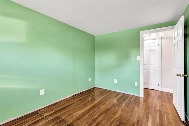 spare room with hardwood / wood-style flooring