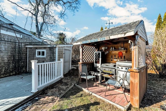 exterior space featuring grilling area and a storage shed