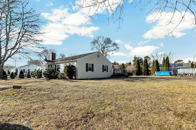 view of side of home with a lawn