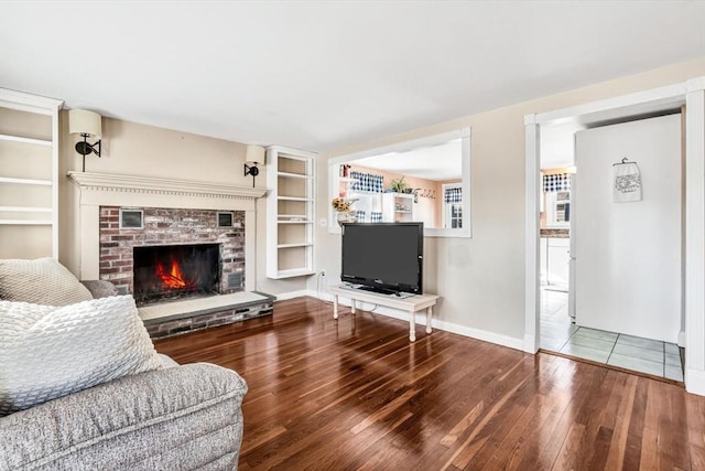 living room featuring wood-type flooring and a fireplace