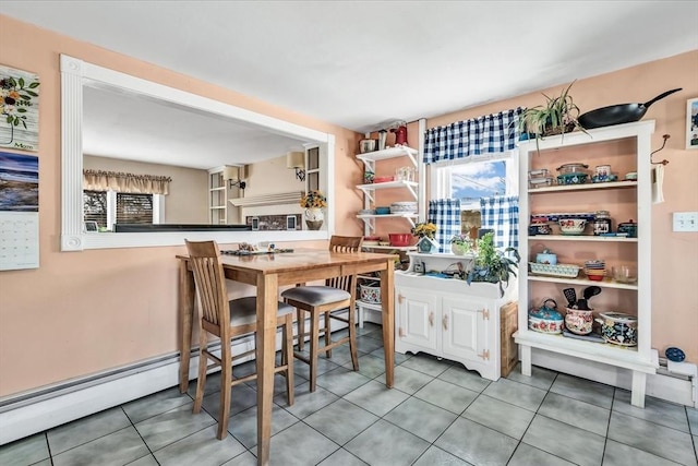 dining area with tile patterned floors and baseboard heating