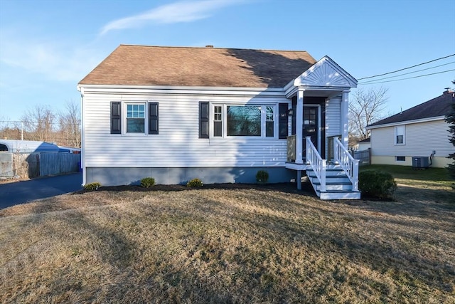 view of front facade featuring cooling unit and a front lawn