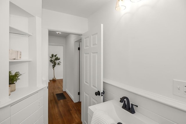 bathroom with hardwood / wood-style floors and sink