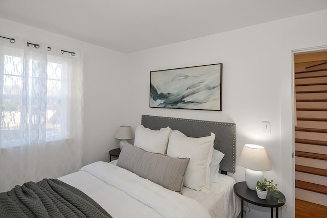 bedroom featuring hardwood / wood-style floors, a spacious closet, and a closet