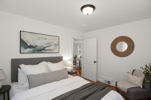 bedroom with hardwood / wood-style floors