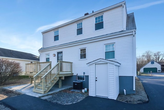 back of house featuring central air condition unit