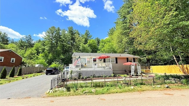 9 Willow Rd, Holbrook, MA 02343 - manufactured / mobile home featuring a fenced front yard, asphalt driveway, and a gate