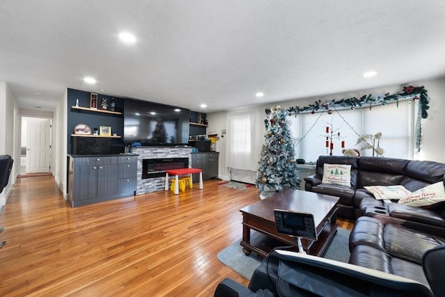 9 Willow Rd, Holbrook, MA 02343 - living area with light wood-style flooring, a stone fireplace, and recessed lighting