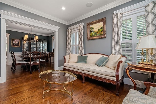 sitting room featuring a notable chandelier, crown molding, wood finished floors, and recessed lighting