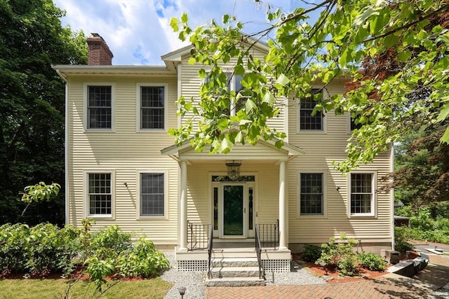 134 Burlington St, Lexington, MA 02420 - view of front of house with a chimney and covered porch