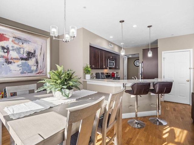 dining room featuring dark hardwood / wood-style flooring and a chandelier