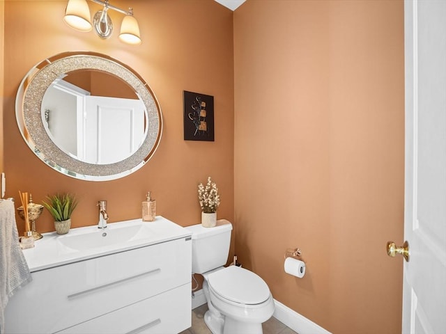 bathroom with tile patterned flooring, vanity, and toilet