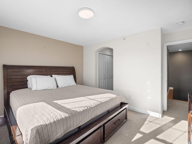 carpeted bedroom with a closet